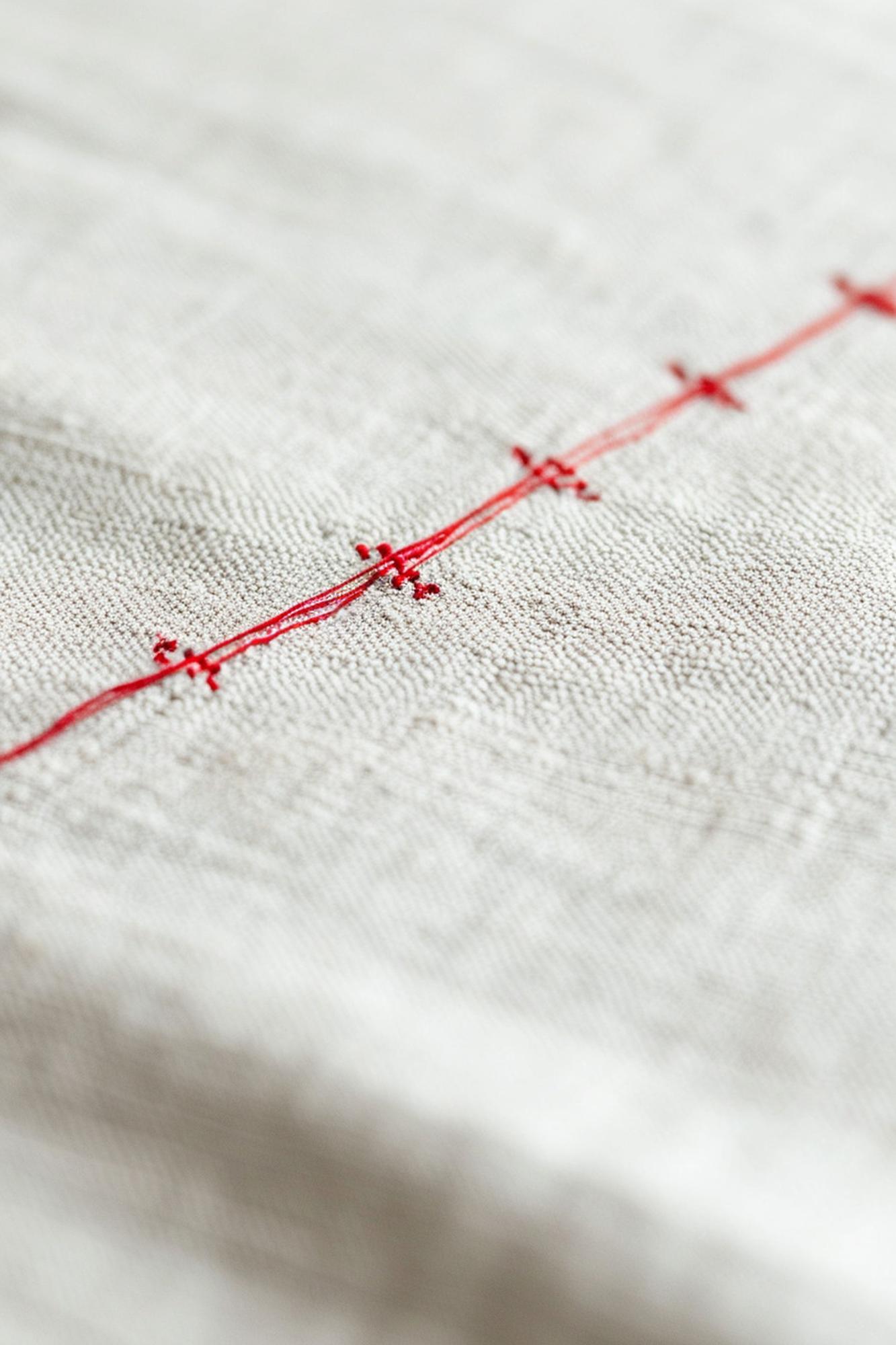 Closeup of artisan embroidery on linen